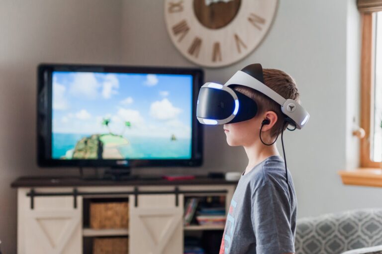 boy wearing a black and white virtual reality goggles